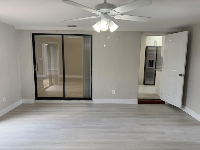 14814 Wildflower Ln, Delray Beach, FL 33446 - spare room featuring a textured wall, baseboards, ceiling fan, and wood finished floors