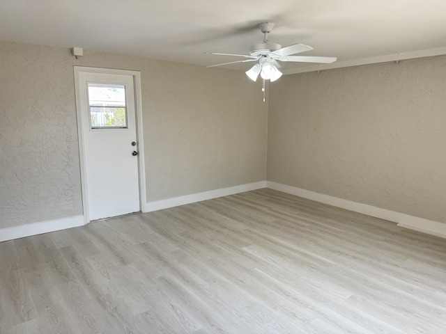 14814 Wildflower Ln, Delray Beach, FL 33446 - empty room featuring ceiling fan, a textured wall, wood finished floors, and baseboards