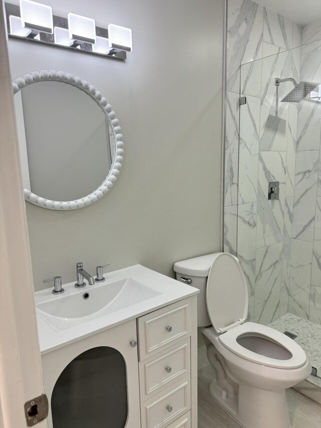 14814 Wildflower Ln, Delray Beach, FL 33446 - bathroom with toilet, a marble finish shower, and vanity