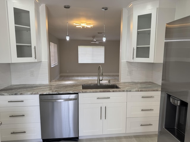 14814 Wildflower Ln, Delray Beach, FL 33446 - kitchen with appliances with stainless steel finishes, a sink, light stone counters, and white cabinets