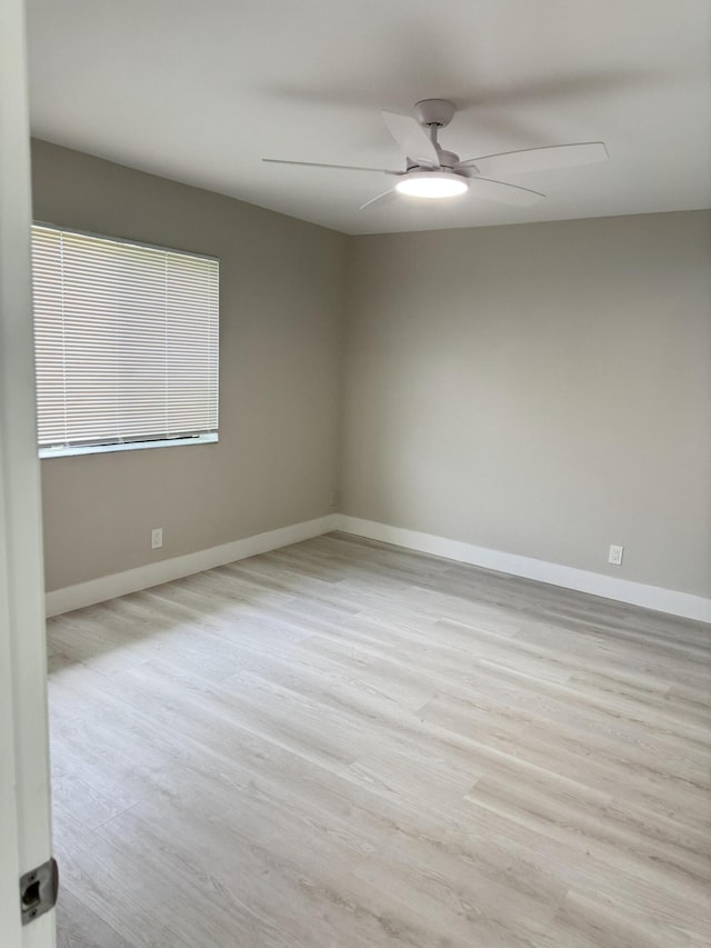 14814 Wildflower Ln, Delray Beach, FL 33446 - empty room with a ceiling fan, wood finished floors, and baseboards