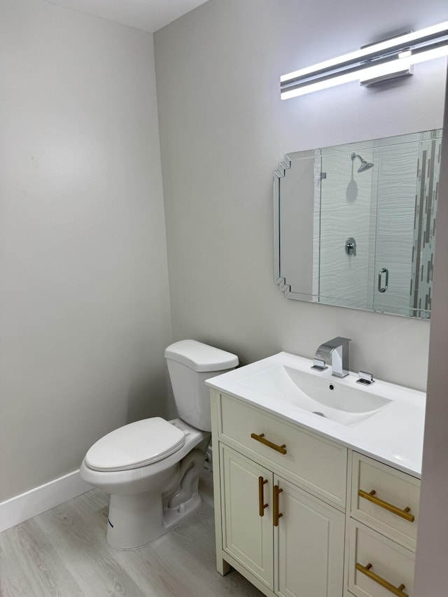 14814 Wildflower Ln, Delray Beach, FL 33446 - full bath featuring a shower stall, toilet, vanity, wood finished floors, and baseboards