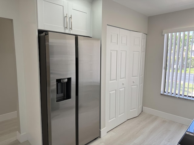 14814 Wildflower Ln, Delray Beach, FL 33446 - kitchen featuring stainless steel fridge, white cabinetry, light wood-type flooring, and baseboards