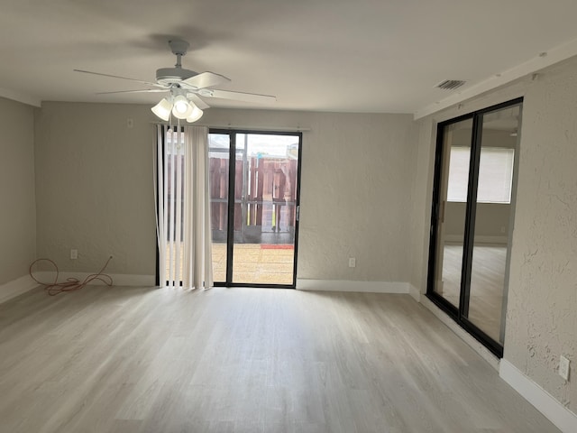 14814 Wildflower Ln, Delray Beach, FL 33446 - spare room with wood finished floors, a textured wall, ceiling fan, and baseboards