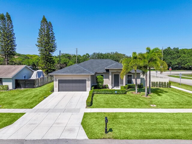 12111 Sugar Pine Trl, Wellington, FL 33414 - ranch-style house featuring an attached garage, concrete driveway, and roof with shingles
