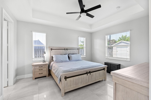 12111 Sugar Pine Trl, Wellington, FL 33414 - bedroom with a raised ceiling, baseboards, ceiling fan, and light tile patterned flooring