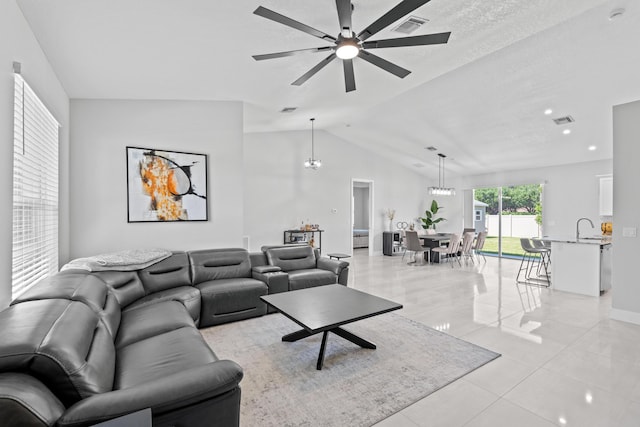 12111 Sugar Pine Trl, Wellington, FL 33414 - living room with ceiling fan, light tile patterned floors, vaulted ceiling, baseboards, and a chandelier