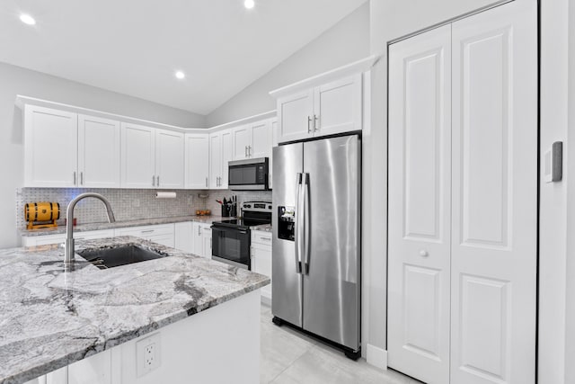 12111 Sugar Pine Trl, Wellington, FL 33414 - kitchen with appliances with stainless steel finishes, a sink, vaulted ceiling, backsplash, and white cabinetry