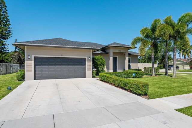 12111 Sugar Pine Trl, Wellington, FL 33414 - prairie-style home featuring an attached garage and concrete driveway