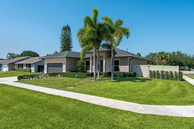 12111 Sugar Pine Trl, Wellington, FL 33414 - ranch-style home with an attached garage and a gate
