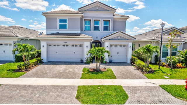 5968 Jasmine Ln, Westlake, FL 33470 - view of front of house featuring a garage, stucco siding, decorative driveway, and a tiled roof