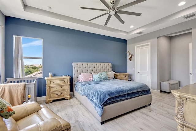 5968 Jasmine Ln, Westlake, FL 33470 - bedroom featuring a raised ceiling, baseboards, recessed lighting, and light wood-style flooring