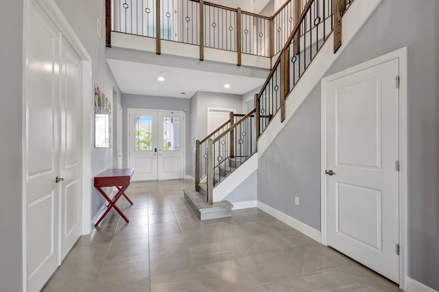 5968 Jasmine Ln, Westlake, FL 33470 - entrance foyer with baseboards, stairway, a high ceiling, french doors, and tile patterned flooring