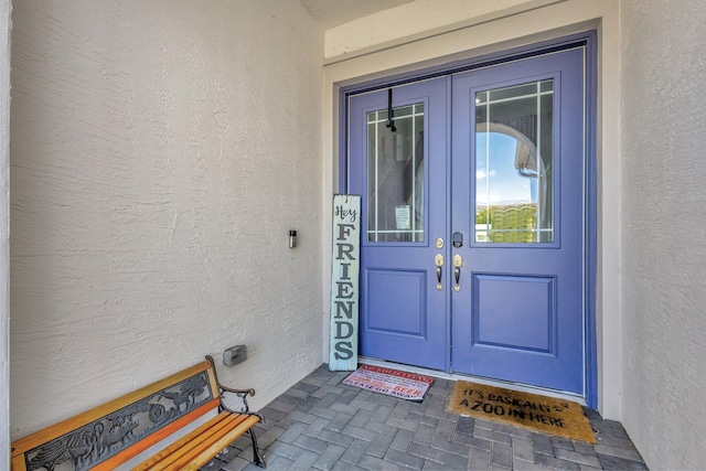 5968 Jasmine Ln, Westlake, FL 33470 - view of exterior entry featuring french doors and stucco siding