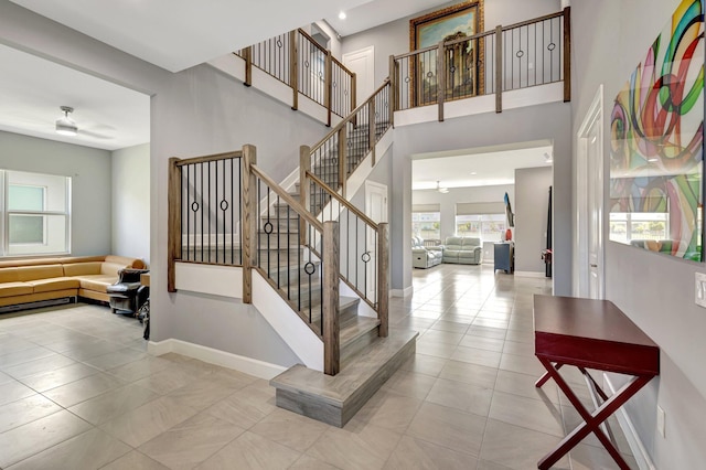 5968 Jasmine Ln, Westlake, FL 33470 - stairway with tile patterned floors, baseboards, a towering ceiling, and ceiling fan
