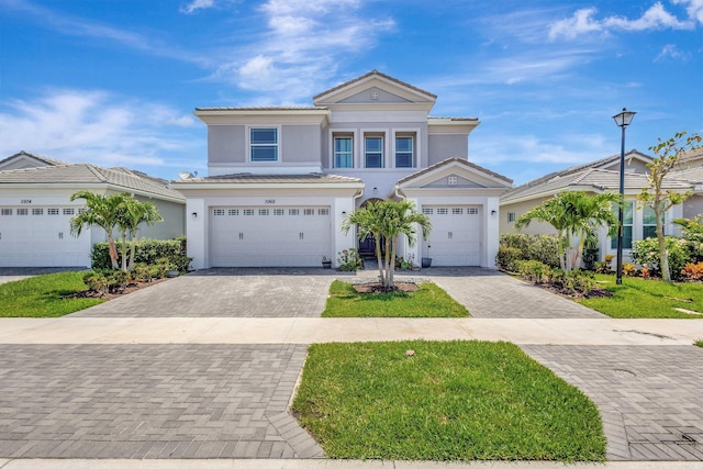 5968 Jasmine Ln, Westlake, FL 33470 - traditional home with decorative driveway, stucco siding, and an attached garage
