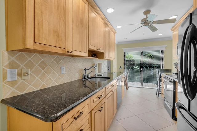kitchen with a sink, range with electric stovetop, freestanding refrigerator, crown molding, and tasteful backsplash