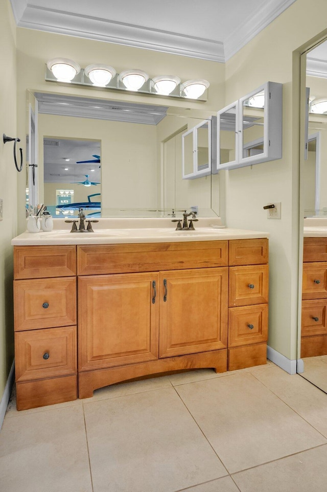 full bathroom with ornamental molding, double vanity, tile patterned floors, and baseboards