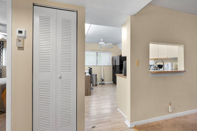 hallway with baseboards and light wood-type flooring
