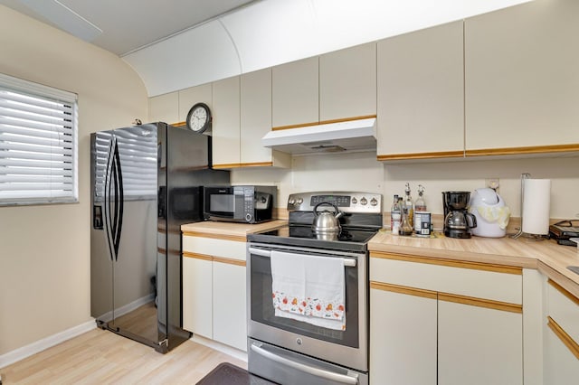kitchen with under cabinet range hood, stainless steel electric range oven, fridge with ice dispenser, light wood finished floors, and black microwave