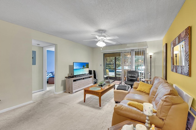 carpeted living area featuring a ceiling fan, a textured ceiling, baseboards, and electric panel