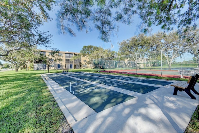 view of home's community with a tennis court and shuffleboard
