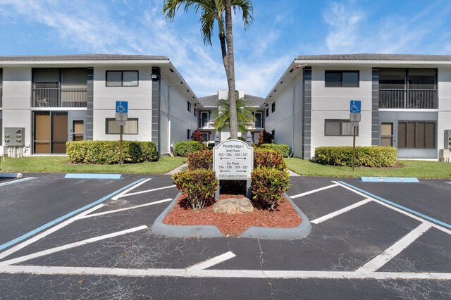 view of building exterior with uncovered parking