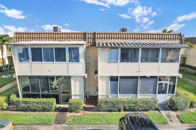 79 Saxony B B, Delray Beach, FL 33446 - rear view of house featuring a chimney