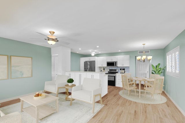 79 Saxony B B, Delray Beach, FL 33446 - living area featuring light wood-style flooring, baseboards, a chandelier, a ceiling fan, and recessed lighting