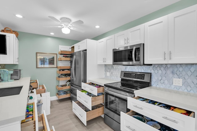 79 Saxony B B, Delray Beach, FL 33446 - kitchen featuring appliances with stainless steel finishes, white cabinets, light countertops, and recessed lighting