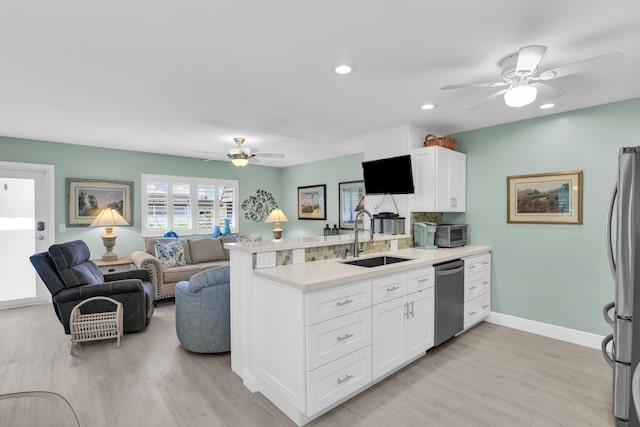 79 Saxony B B, Delray Beach, FL 33446 - kitchen featuring a sink, stainless steel appliances, a ceiling fan, a peninsula, and recessed lighting