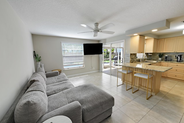 10687 Katmandu Ct, Boynton Beach, FL 33437 - living room featuring a ceiling fan, light tile patterned floors, baseboards, and a textured ceiling
