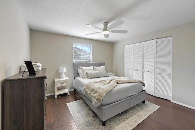 10687 Katmandu Ct, Boynton Beach, FL 33437 - bedroom with dark wood-style flooring, a textured ceiling, a closet, baseboards, and a ceiling fan
