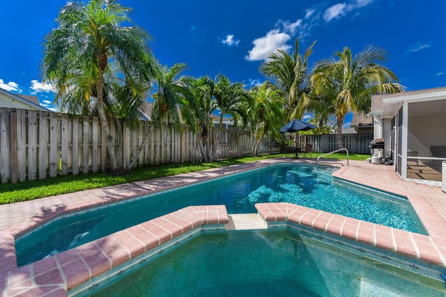 10687 Katmandu Ct, Boynton Beach, FL 33437 - view of pool featuring a fenced backyard, a pool with connected hot tub, and area for grilling