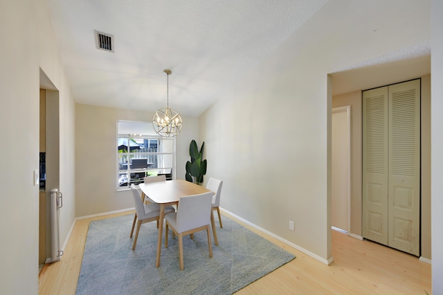 10687 Katmandu Ct, Boynton Beach, FL 33437 - dining room with a chandelier, light wood-style floors, and baseboards