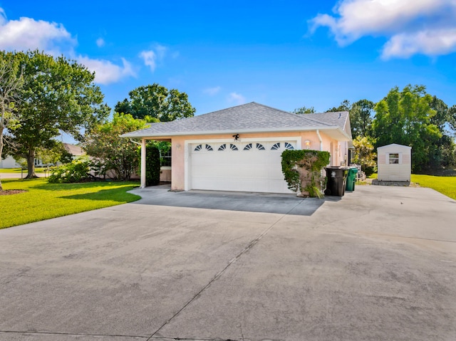 5910 NW Bayou Ct, Port Saint Lucie, FL 34986 - view of front of home with a front lawn, concrete driveway, an outdoor structure, a garage, and stucco siding