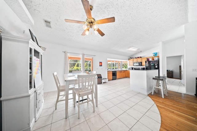 5910 NW Bayou Ct, Port Saint Lucie, FL 34986 - dining area with a textured ceiling, ceiling fan, lofted ceiling, and light tile patterned floors