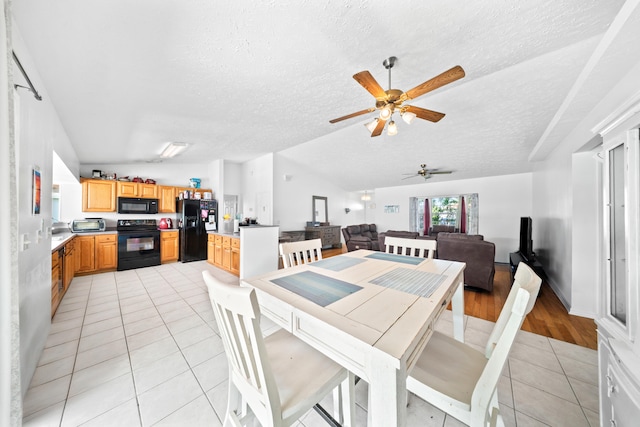5910 NW Bayou Ct, Port Saint Lucie, FL 34986 - dining area with light tile patterned flooring, lofted ceiling, ceiling fan, and a textured ceiling