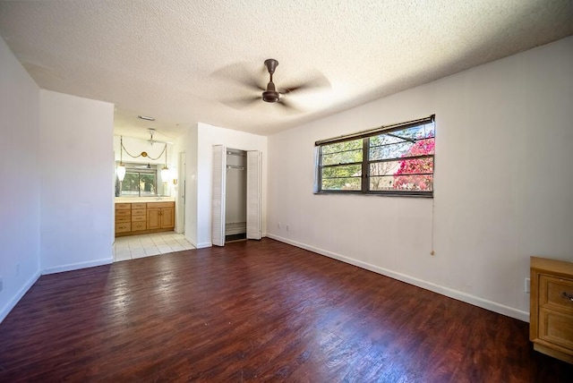 4424 Regency Dr, Lake Worth, FL 33461 - unfurnished bedroom with wood finished floors, baseboards, a textured ceiling, and a closet