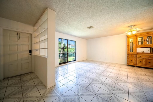 4424 Regency Dr, Lake Worth, FL 33461 - foyer entrance with a ceiling fan, a textured ceiling, and light tile patterned floors