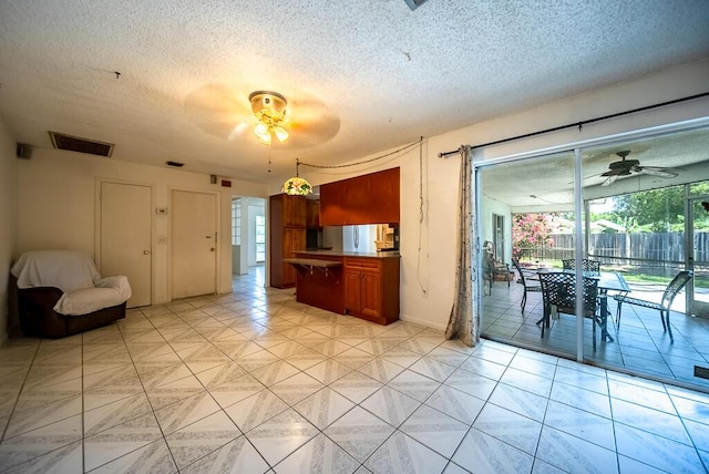 4424 Regency Dr, Lake Worth, FL 33461 - kitchen with ceiling fan, a textured ceiling, and baseboards