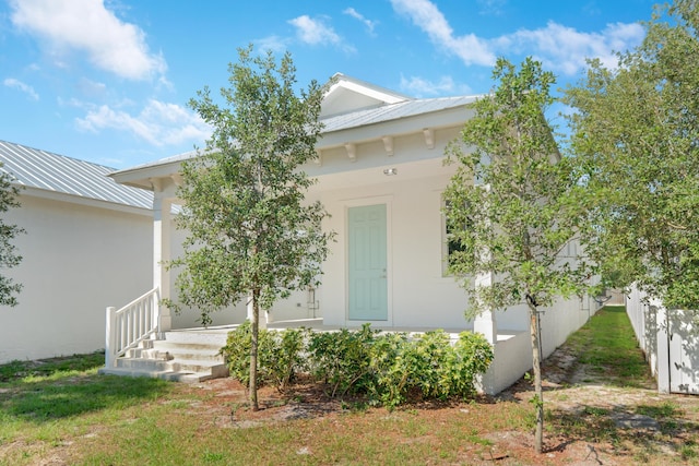 4982 SE Railway Ave, Stuart, FL 34997 - view of exterior entry with metal roof and stucco siding