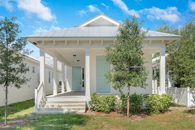 4982 SE Railway Ave, Stuart, FL 34997 - view of front facade with fence, a standing seam roof, and metal roof