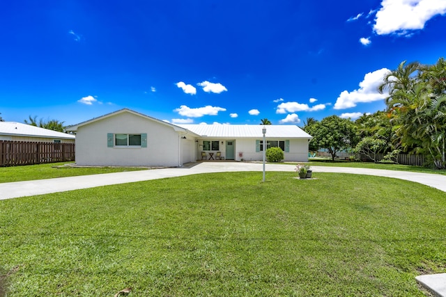 ranch-style house with driveway, a garage, and a patio area