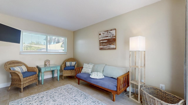 living area featuring baseboards and wood finished floors