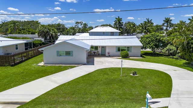 view of front of property with curved driveway and metal roof