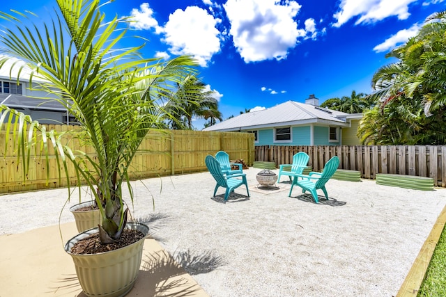 view of patio with a fire pit and fence