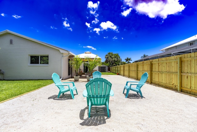 view of patio featuring a storage shed, an outdoor structure, and a fenced backyard