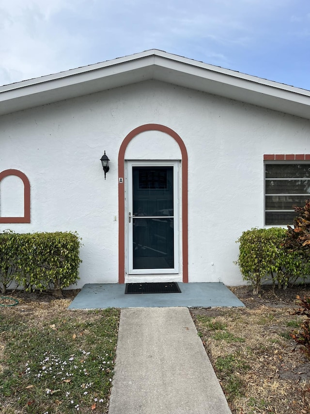 13852 Via Flora Unit A, Delray Beach, FL 33484 - doorway to property with stucco siding