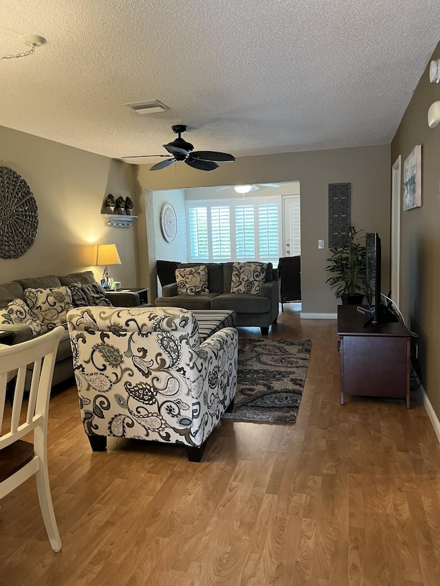 13852 Via Flora Unit A, Delray Beach, FL 33484 - living area with a textured ceiling, a ceiling fan, and wood finished floors